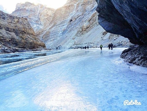 Frozen Ladakh winter landscape with snow covered mountains and Chadar Trek on the frozen Zanskar River in extreme cold
