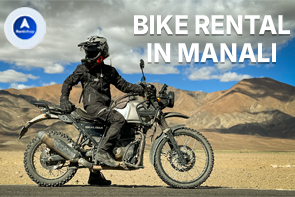 Bike rental in Manali rider with motorcycle against scenic Himalayan mountains